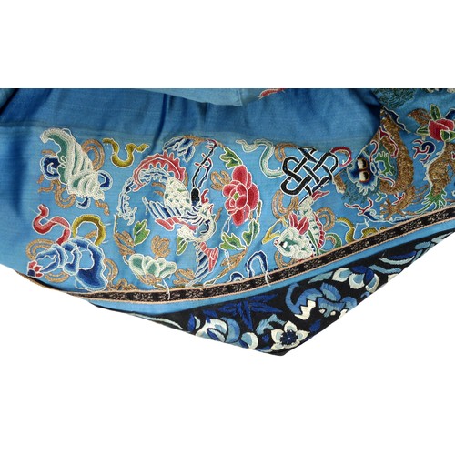 25 - An early 20th century silk Chinese robe, with navy blue ground and intricately embroidered with butt... 