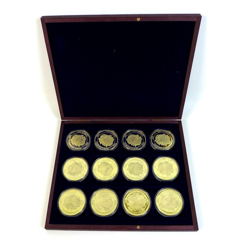 73 - A QEII commemorative coin set, twelve gold plated 50mm coins 'celebrating Her Majesty Queen Elizabet... 