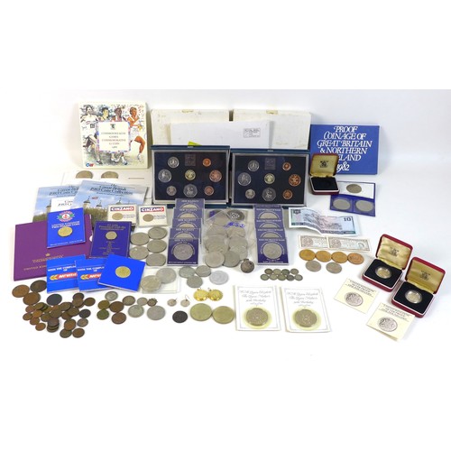 74 - A collection of British coinage, including two sterling silver proof 1983 £1 coins, three proof sets... 