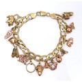 A 9ct yellow gold charm bracelet, kerb link with lobster claw clasp, fitted with sixteen 9ct yellow ... 