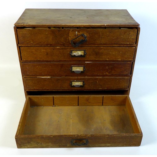 90 - A collection of watch parts, contained within an oak five drawer table top chest, comprising a large... 