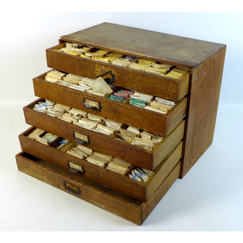 90 - A collection of watch parts, contained within an oak five drawer table top chest, comprising a large... 