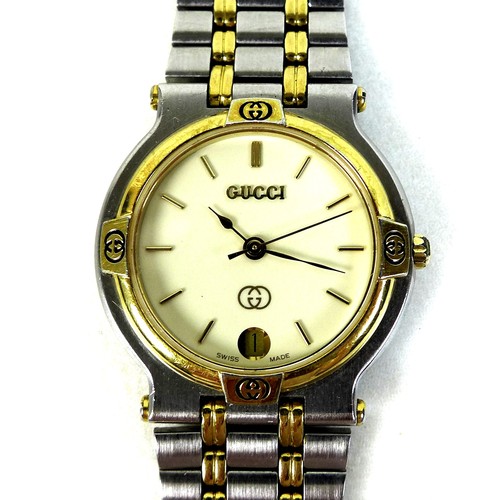 113 - A Gucci 9000M stainless steel and gold plated wristwatch, circular ivory coloured dial with gold bat... 