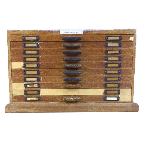 92 - A collection of watch parts, contained within an oak ten drawer table top chest, labelled 'A Beechpa... 