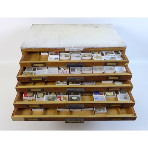 92 - A collection of watch parts, contained within an oak ten drawer table top chest, labelled 'A Beechpa... 