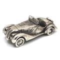 A contemporary novelty silver model car, modelled as a vintage open top sports car, with rolling whe... 