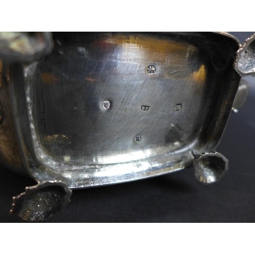 61 - A George III silver teapot and matching milk jug, of London shape with basket weave and stiff leaf b... 