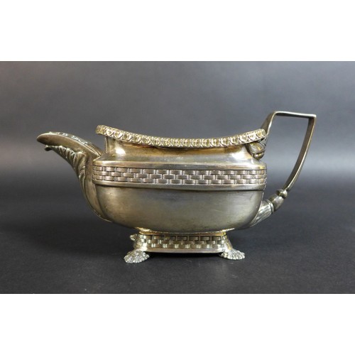 61 - A George III silver teapot and matching milk jug, of London shape with basket weave and stiff leaf b... 