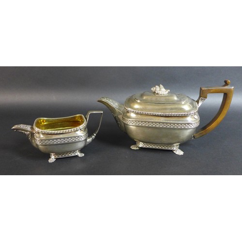 61 - A George III silver teapot and matching milk jug, of London shape with basket weave and stiff leaf b... 