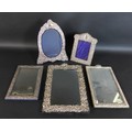Three silver mounted table mirrors, all with blank cartouches, comprising of two Victorian rectangul... 
