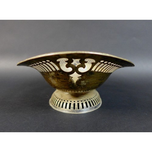 44 - An Edward VII silver bon bon dish, of oval form with pierced decoration raised upon a raised base, T... 