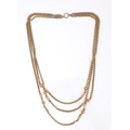 A 9ct gold three strand necklace, each rolo link strand with two decorative orbs, hoop and clasp end... 
