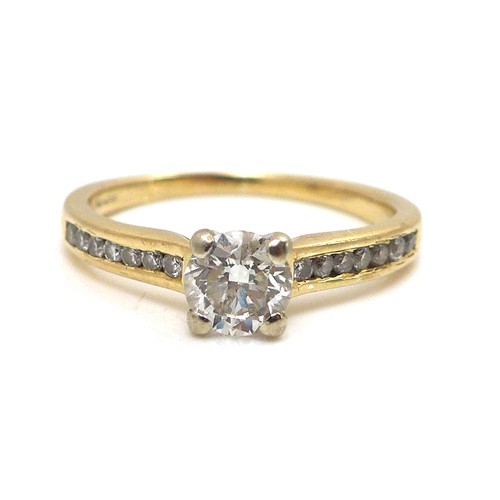 257 - An 18ct yellow gold and diamond solitaire ring, the 0.5ct brilliant cut stone flanked on each should... 