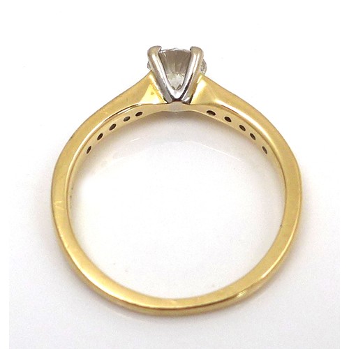 257 - An 18ct yellow gold and diamond solitaire ring, the 0.5ct brilliant cut stone flanked on each should... 