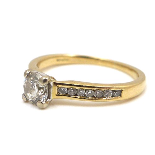 257 - An 18ct yellow gold and diamond solitaire ring, the 0.5ct brilliant cut stone flanked on each should... 