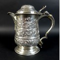 A George III silver stein with later fitted spout, the lid and main body with decorative repousse sc... 
