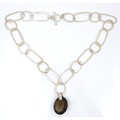 An interesting Modernist design silver necklace with large smokey quartz pendant, the chain of twent... 