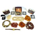 A collection of amber and costume jewellery including a necklace of rough cut butterscotch amber a f... 