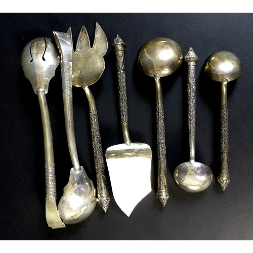 65 - A large collection of Cambodian Khmer silver serving utensils, comprising three graduated ladles, fo... 