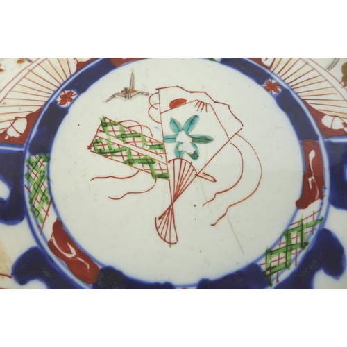 10 - A 19th century Japanese Imari charger, decorated with a fan and origami bird to the centre, 37cm dia... 