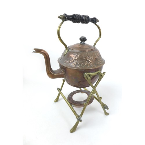 63 - A group of copper and brass items, including an embossed spirit kettle, burner and stand, kettle, 21... 