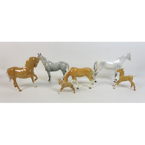 48 - A group of Beswick horses, ponies and foals, comprising two Palamino horses with two foals family gr... 