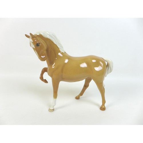 48 - A group of Beswick horses, ponies and foals, comprising two Palamino horses with two foals family gr... 