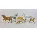 A group of Beswick horses, ponies and foals, comprising two Palamino horses with two foals family gr... 