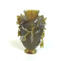 A Chinese agate vase, 19th century, intricately carved with chrysanthemums and trailing foliage.