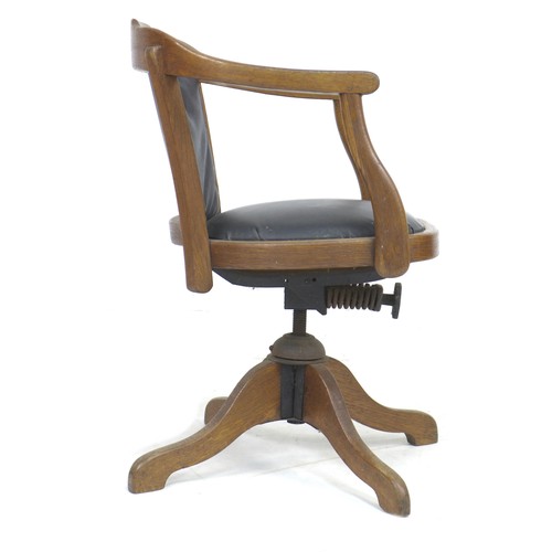 236 - A vintage oak framed office swivel chair, circa 1930, with shaped arms, black leatherette seat and b... 