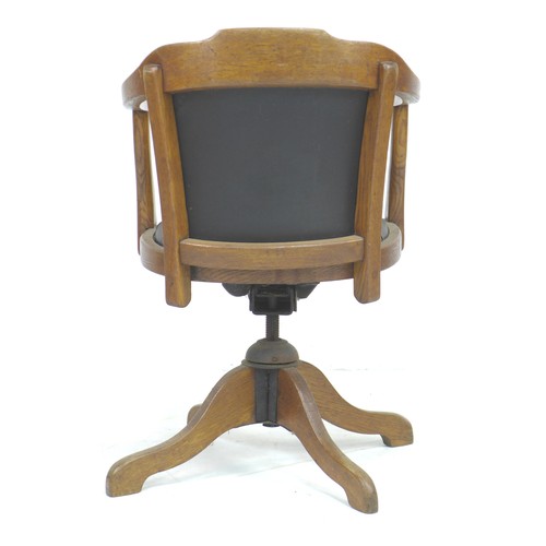 236 - A vintage oak framed office swivel chair, circa 1930, with shaped arms, black leatherette seat and b... 