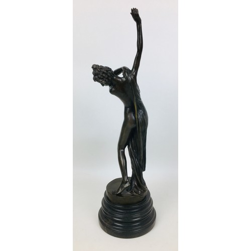 64 - A late 20th century bronzed metal semi-clad female sculpture, unsigned, on a turned circular marble ... 