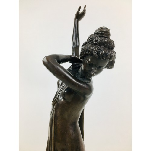 64 - A late 20th century bronzed metal semi-clad female sculpture, unsigned, on a turned circular marble ... 