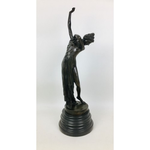 64 - A late 20th century bronzed metal semi-clad female sculpture, unsigned, on a turned circular marble ... 