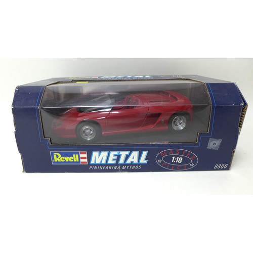 Four Revell die-cast 1:18 scale model sports cars, comprising a
