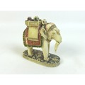 A 19th century carved ivory Indian elephant, carrying a rider and two passengers, with hand painted ... 