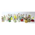 A group porcelain figurines of young ladies including a Lladro figurine of a young lady holding flow... 