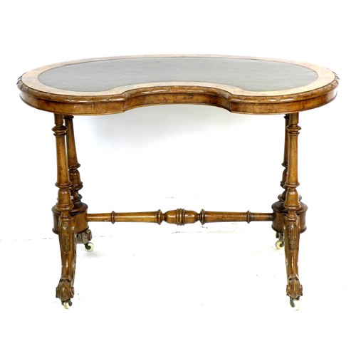 338 - A Victorian walnut kidney shaped table, with amended turned supports and shaped legs with castors, 9... 