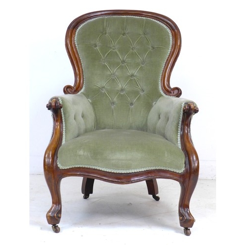 339 - A Victorian mahogany spoon back armchair, buttoned green velvet upholstery, raised on shaped legs an... 