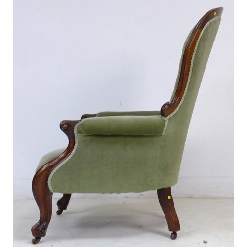 339 - A Victorian mahogany spoon back armchair, buttoned green velvet upholstery, raised on shaped legs an... 