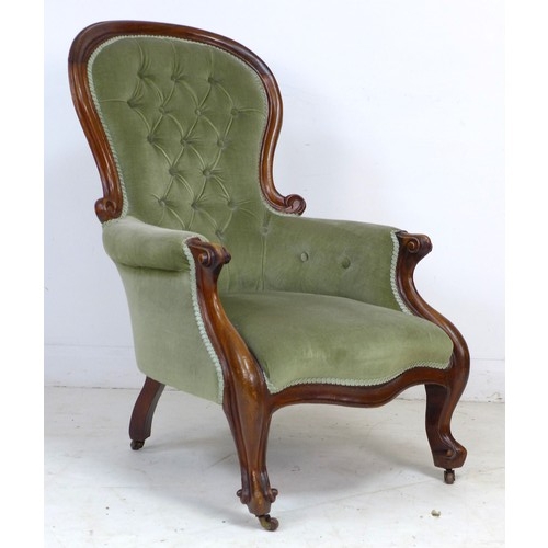 339 - A Victorian mahogany spoon back armchair, buttoned green velvet upholstery, raised on shaped legs an... 