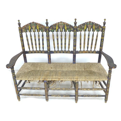 356 - A Spanish painted rush seated three seater settee, early 20th century, with shaped open arms and lad... 