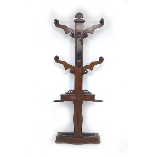 335 - A Victorian mahogany hall stand, the shaped upright with four arms and eight turned pegs, glove comp... 