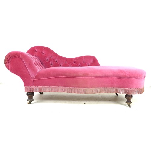 351 - A Victorian chaise longue, with shaped arm and scroll end, upholstered in pink buttoned velvet, rais... 