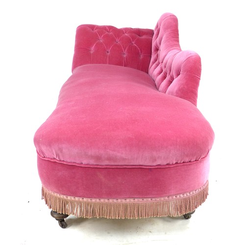 351 - A Victorian chaise longue, with shaped arm and scroll end, upholstered in pink buttoned velvet, rais... 