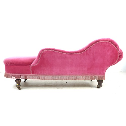 351 - A Victorian chaise longue, with shaped arm and scroll end, upholstered in pink buttoned velvet, rais... 