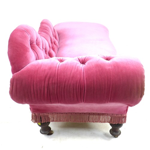 351 - A Victorian chaise longue, with shaped arm and scroll end, upholstered in pink buttoned velvet, rais... 