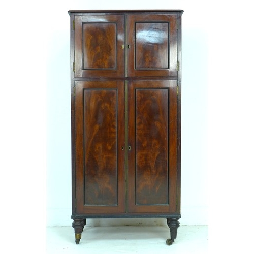 357 - A mid 19th century mahogany cupboard, two double cupboard doors with brass edging, the smaller upper... 