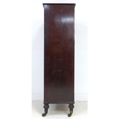 357 - A mid 19th century mahogany cupboard, two double cupboard doors with brass edging, the smaller upper... 