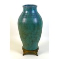An Upchurch Pottery vase, circa 1930, of baluster form decorated in a blue green drip glaze, gilt me... 